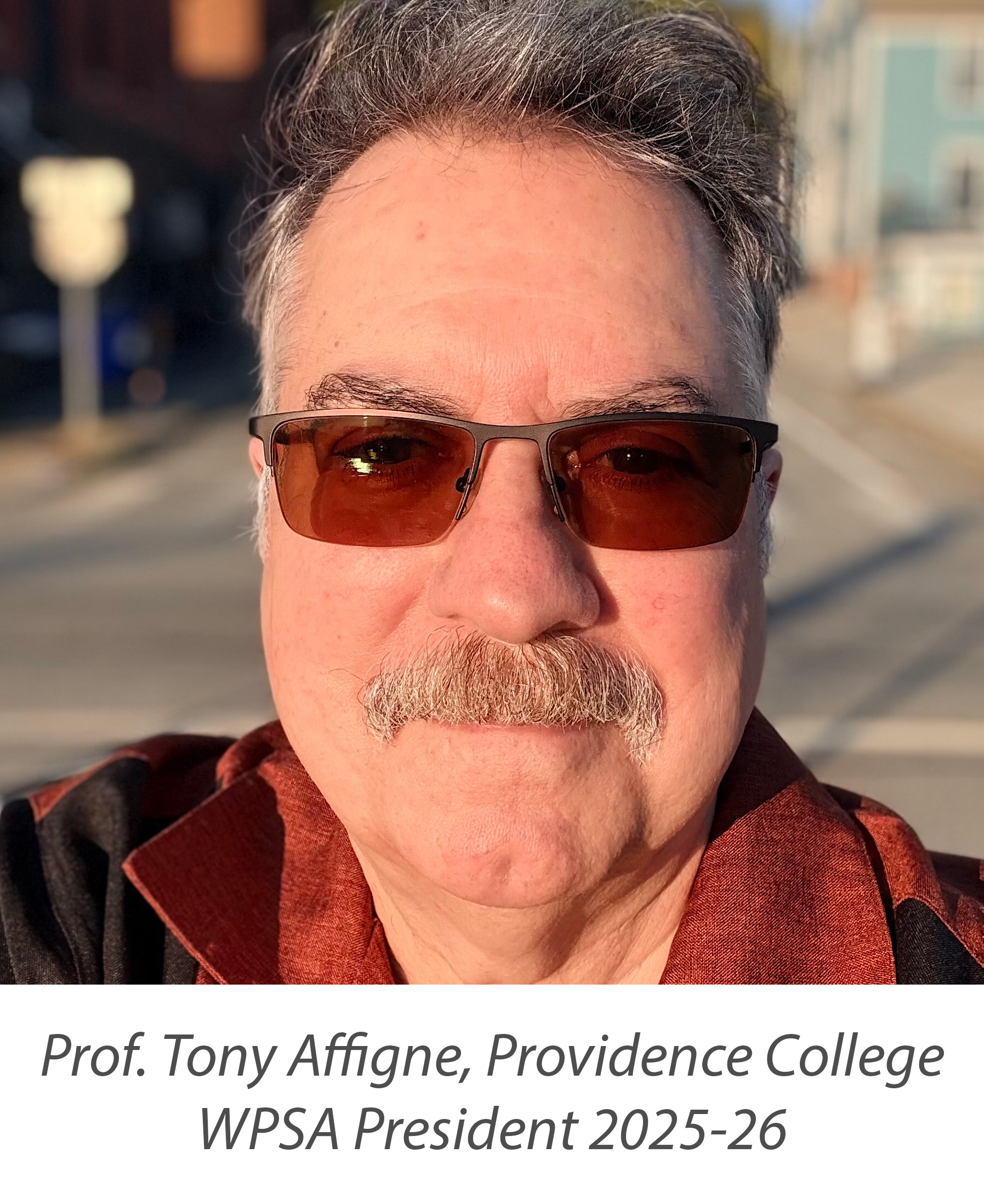 Tony Affigne wearing sunglasses, smiling, and facing us.